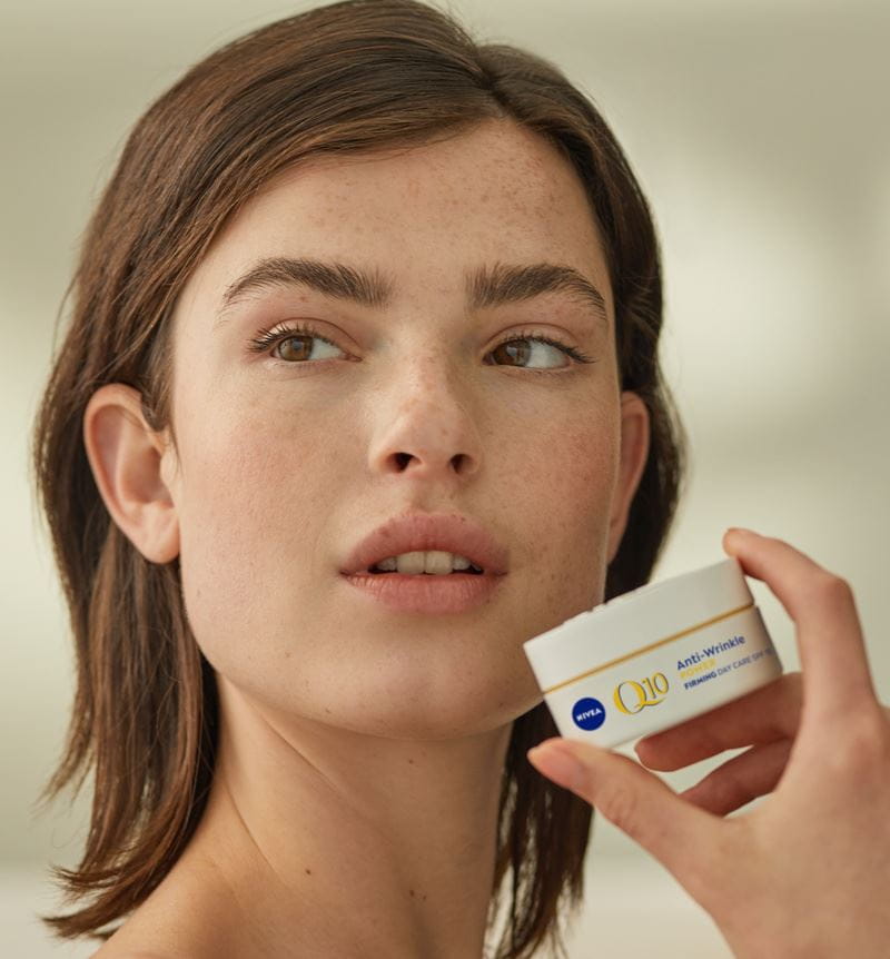 woman using Nivea Q10 Anti wrinkles cream