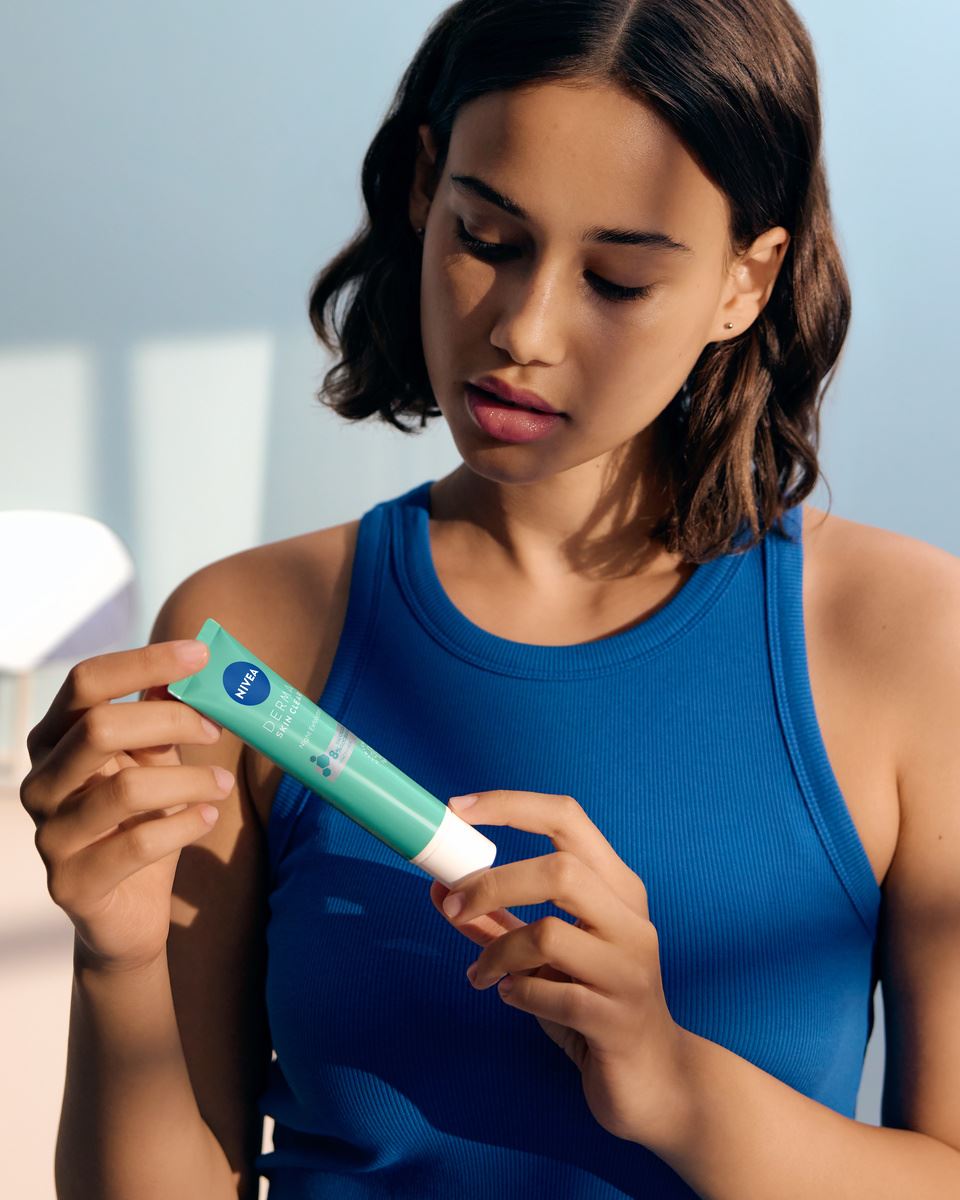 young woman using Nivea DermaSkin product