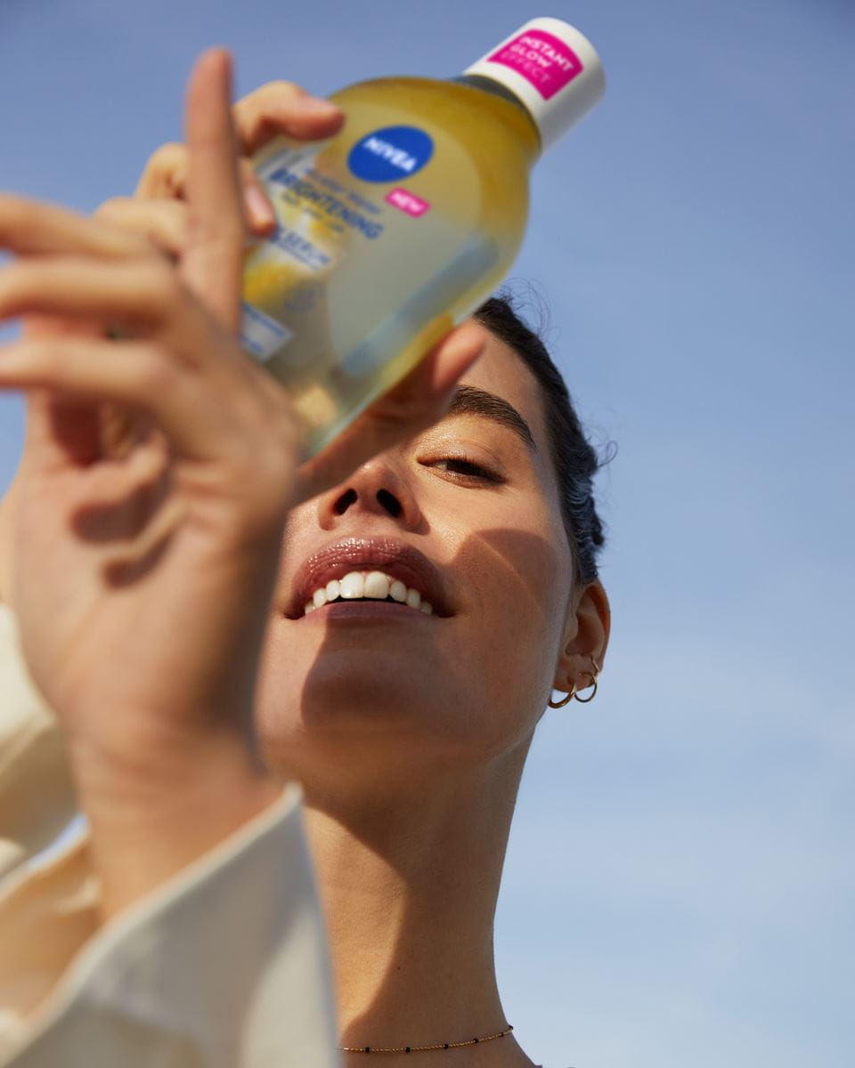 Mujer joven usando NIVEA Agua Micelar Regeneradora + 5% Serum con Pantenol y Escualano
