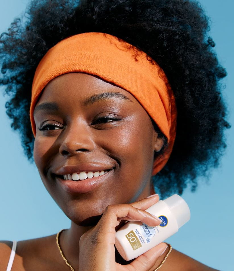 young woman using Nivea Sun UV Face Specialist face cream
