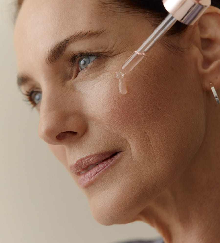 woman applying serum