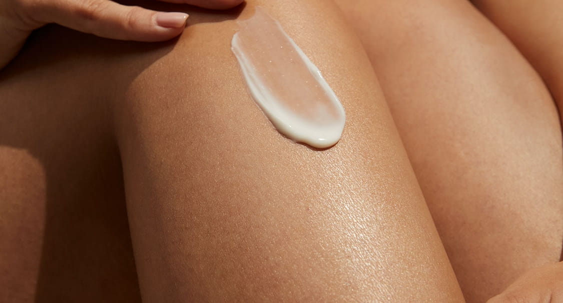 Frau, die Gesichtscreme aufträgt