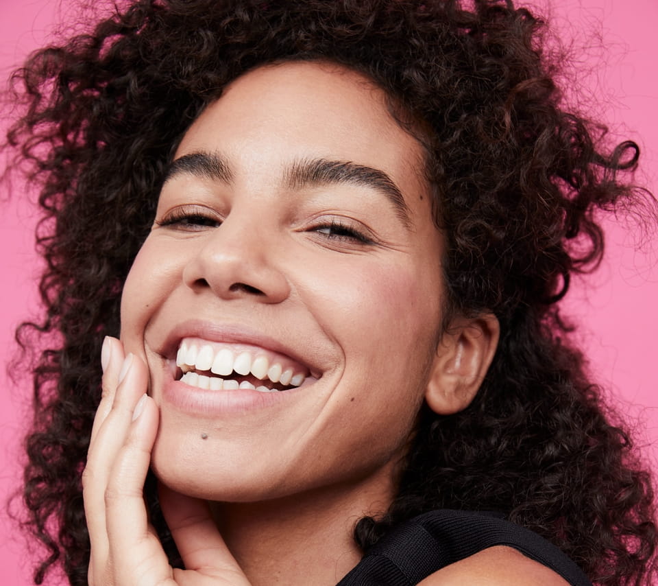woman holding a Nivea Sun Spot Control Face Cream