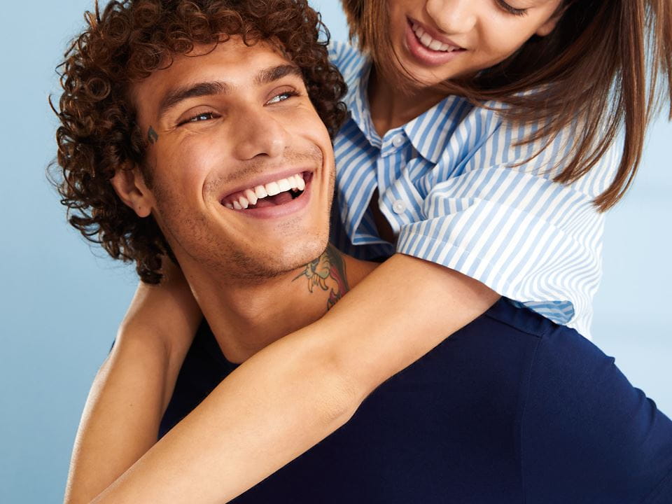 lady smiling while holding an avocado