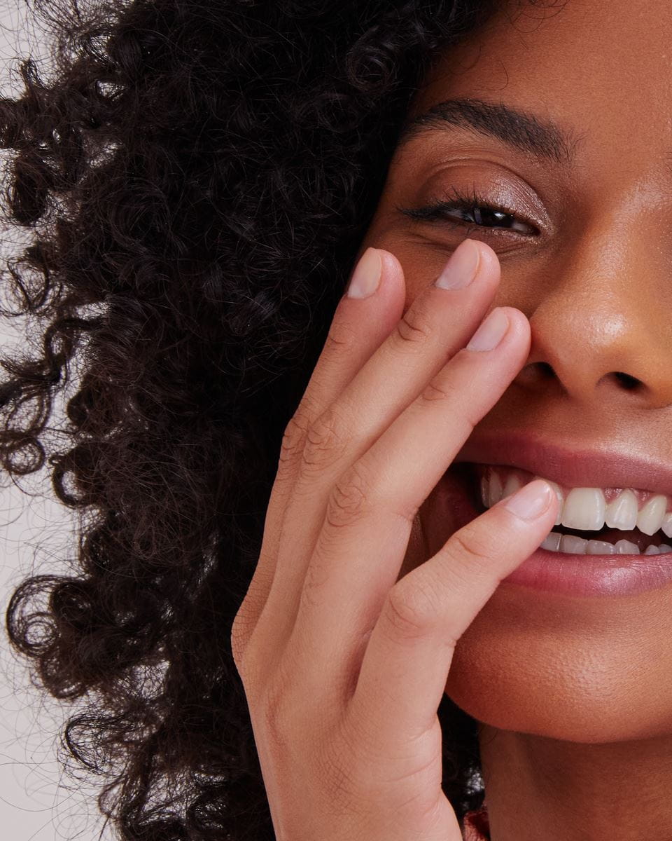 girl with curly hair, smiling