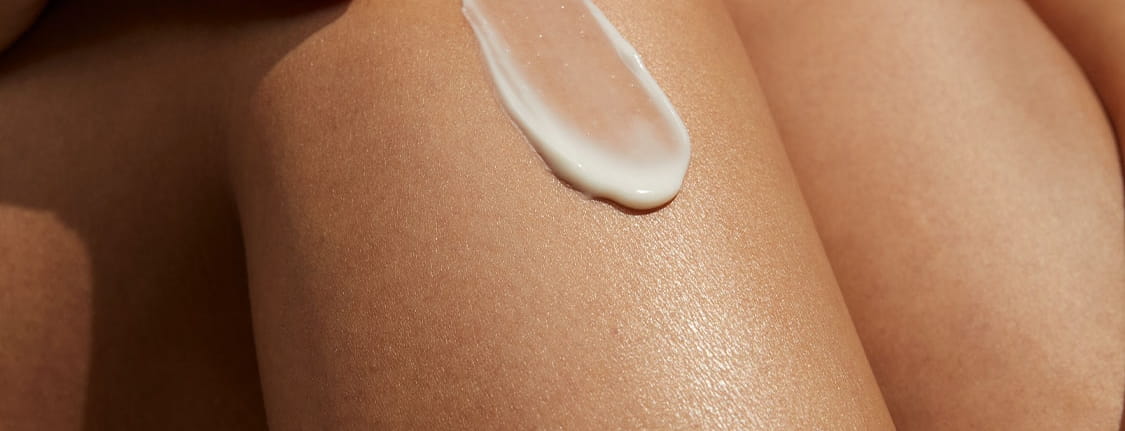 woman applying serum on her face