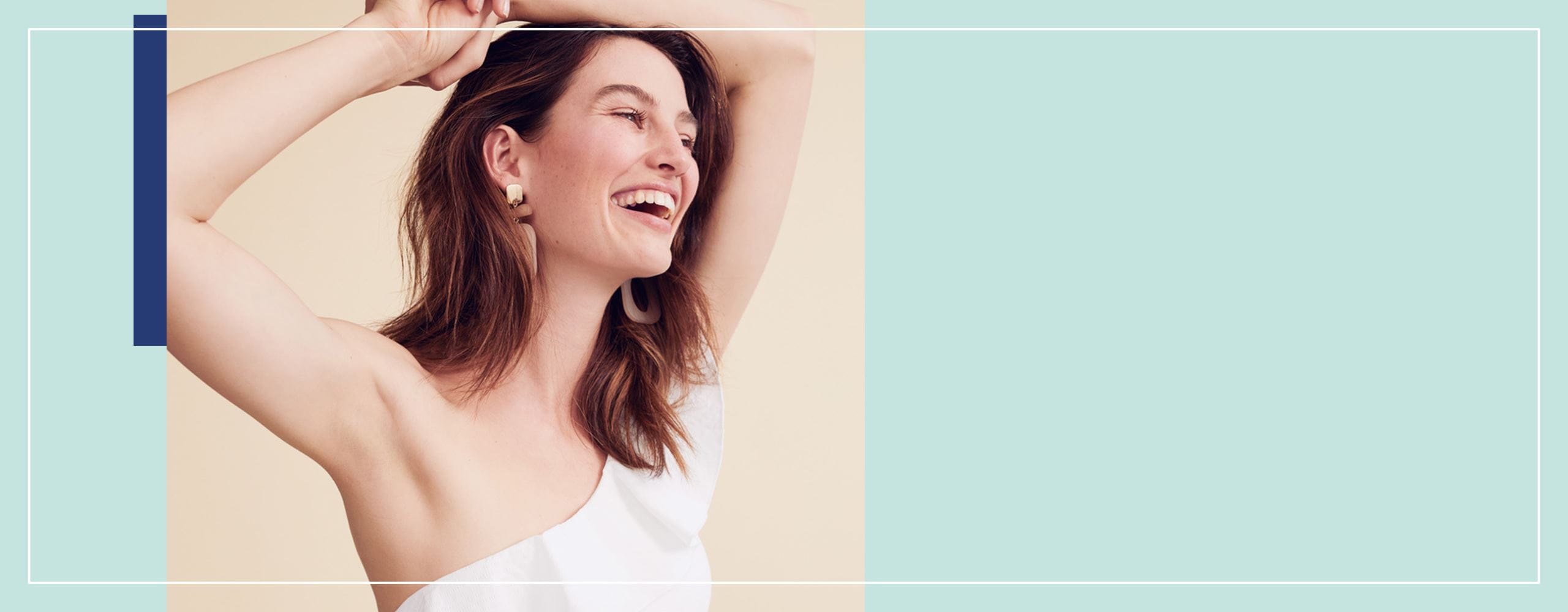 lady smiling with her arms in the air