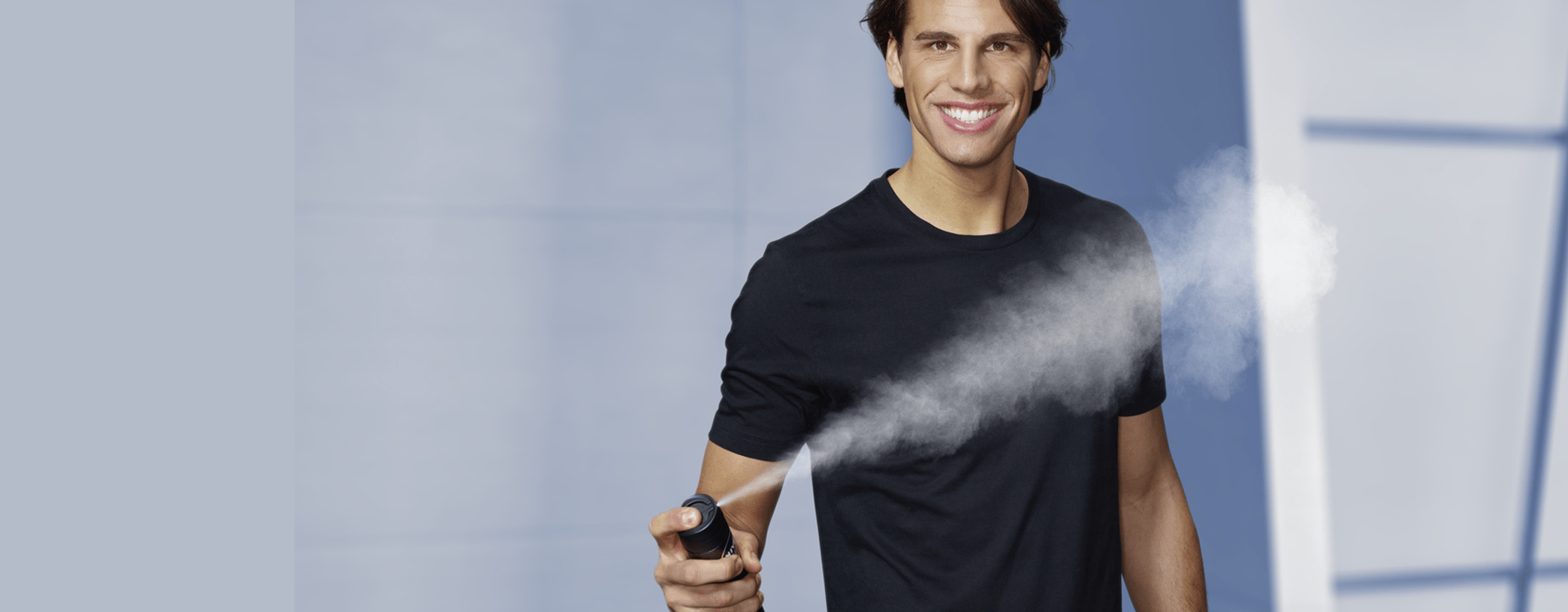 man holding deo spray