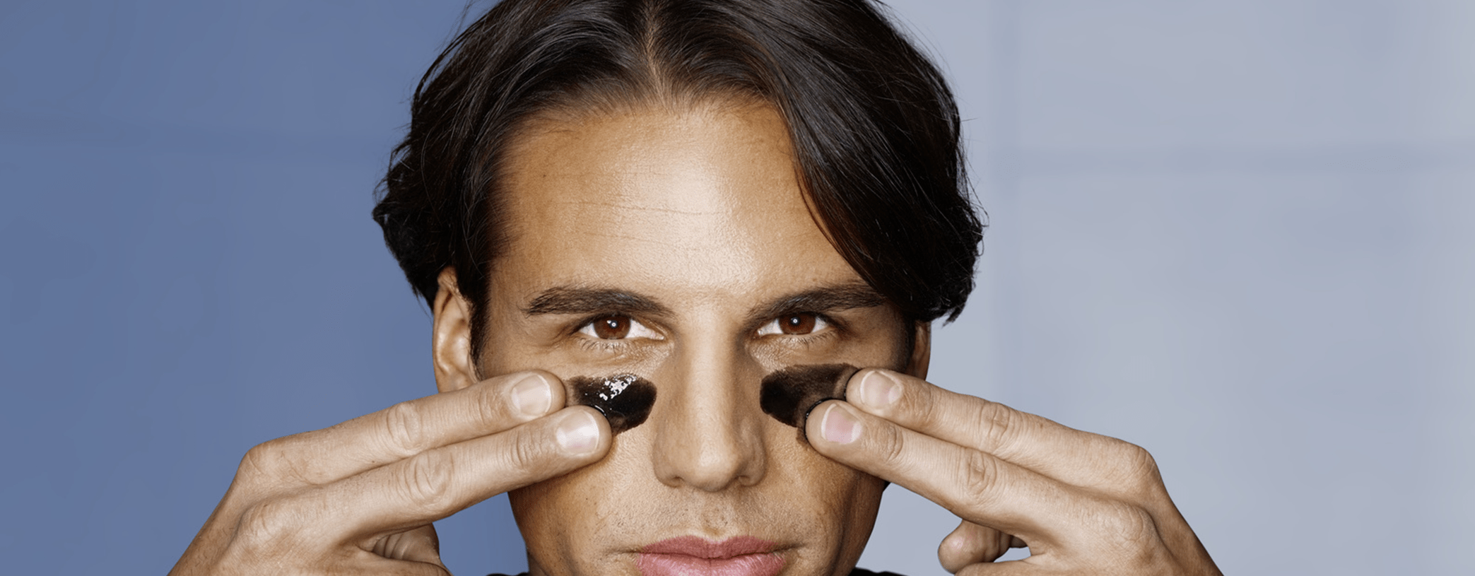 Men applying black mask