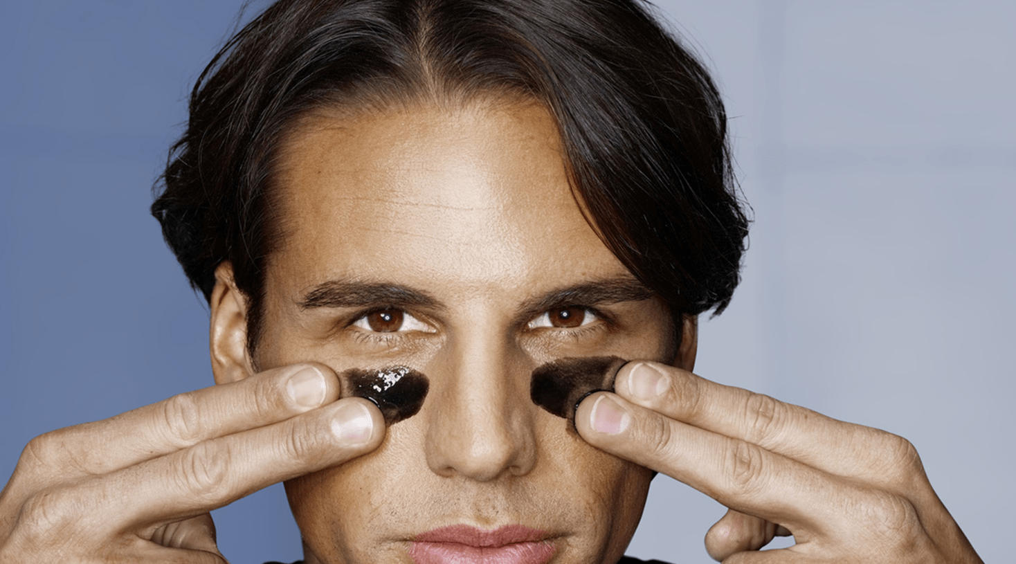 Men applying black mask