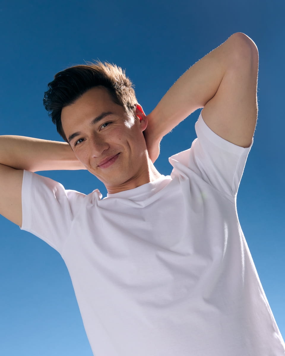 Men smiling under the blue sky