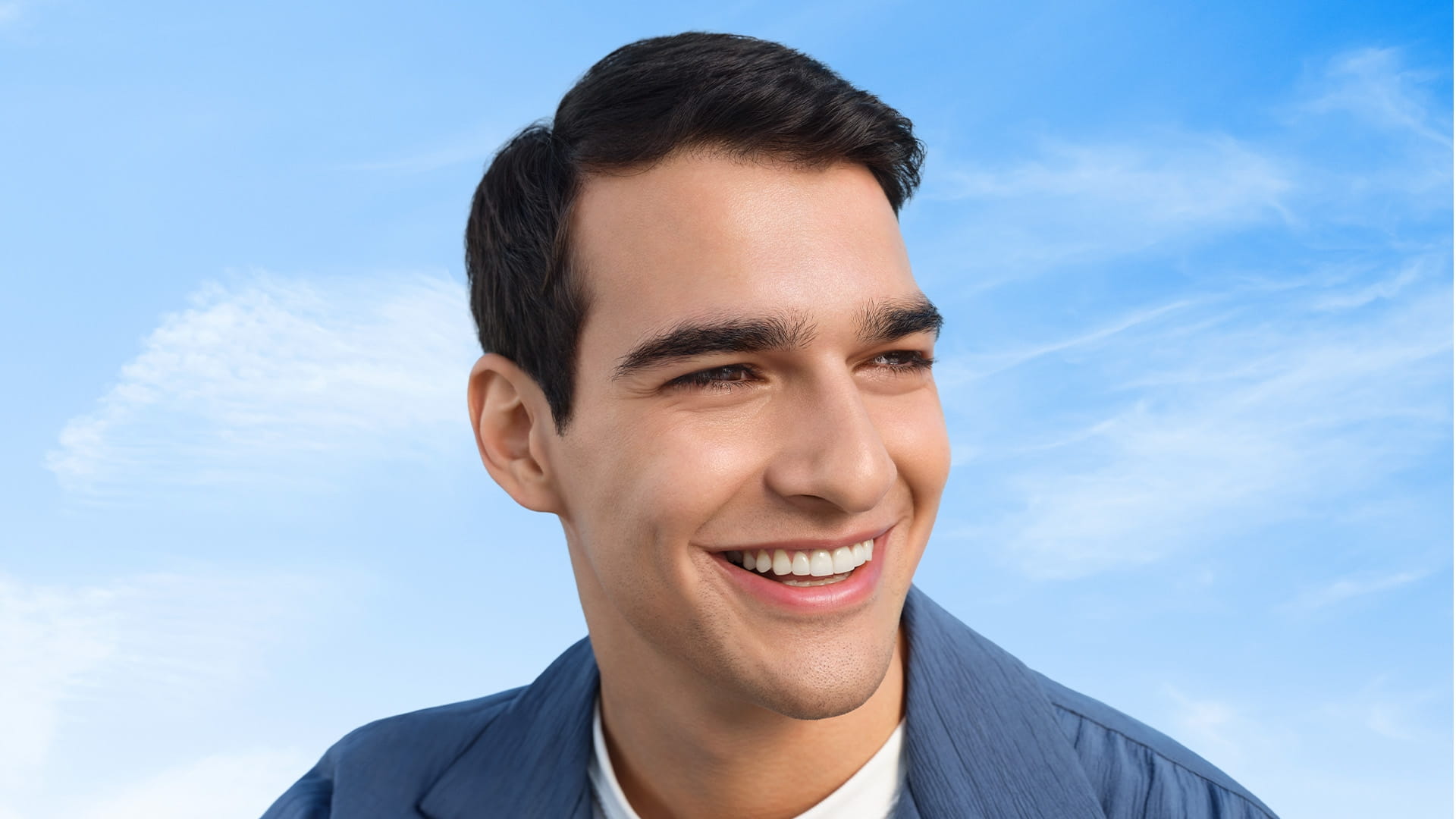 Smiling man under a blue sky