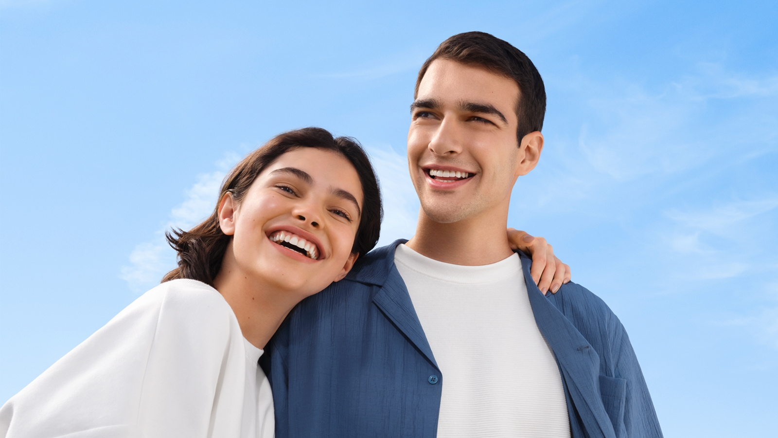 Man and woman smiling under the blue sky
