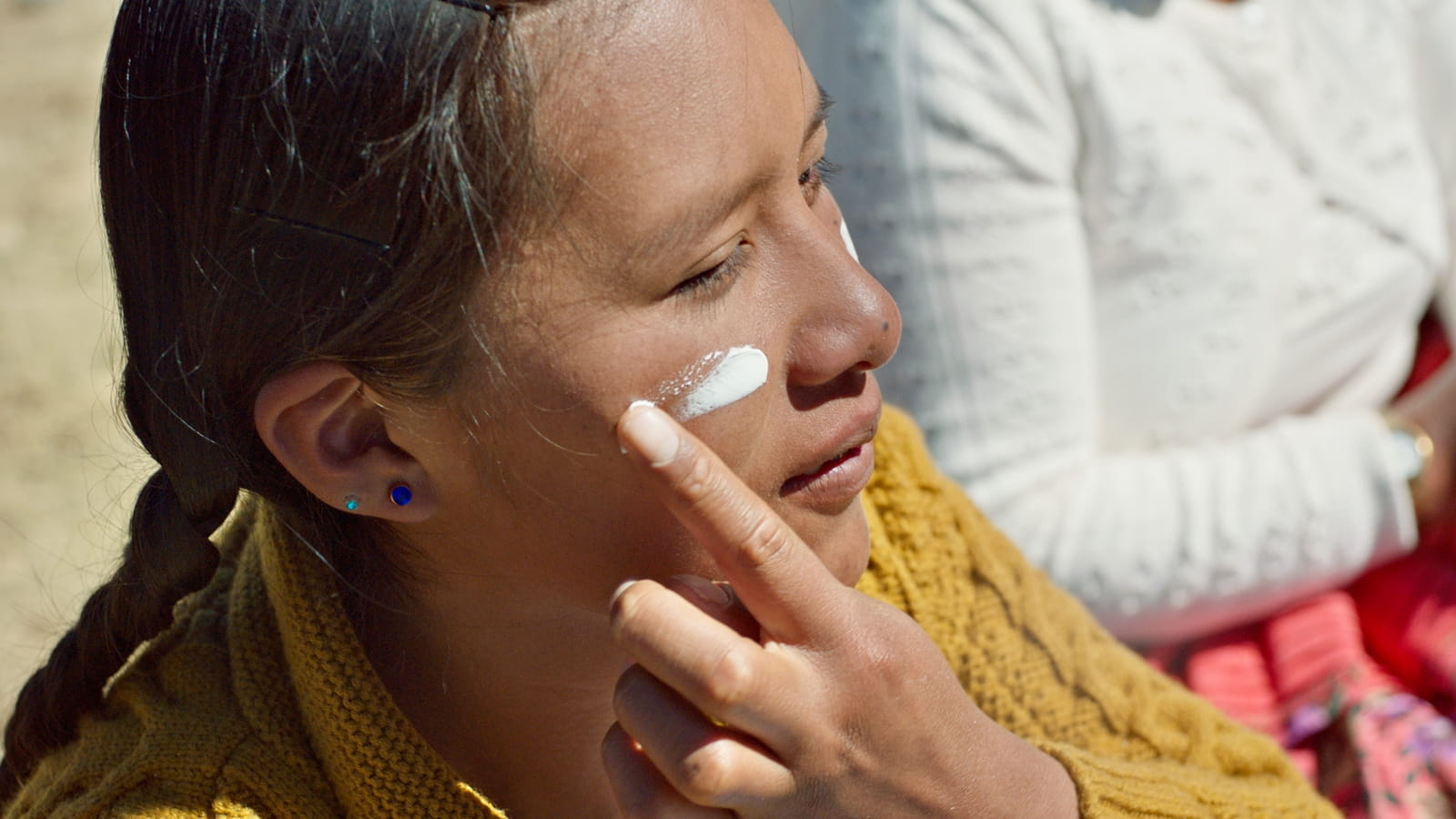 Women swipe creme on her face