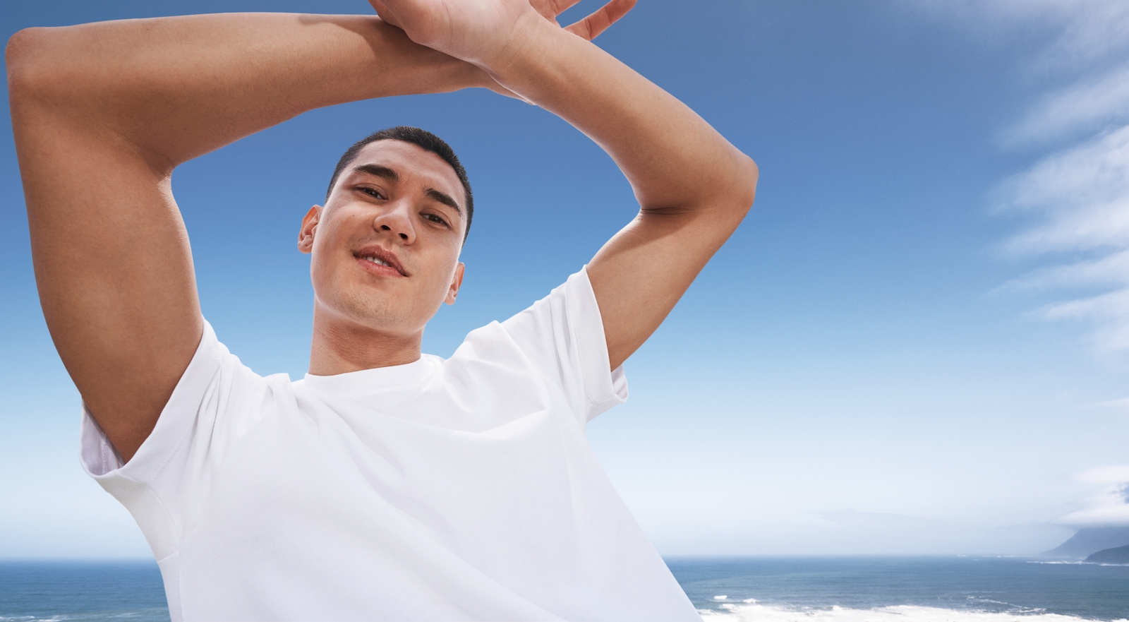 Men on the sea with white shirt under the blue sky 