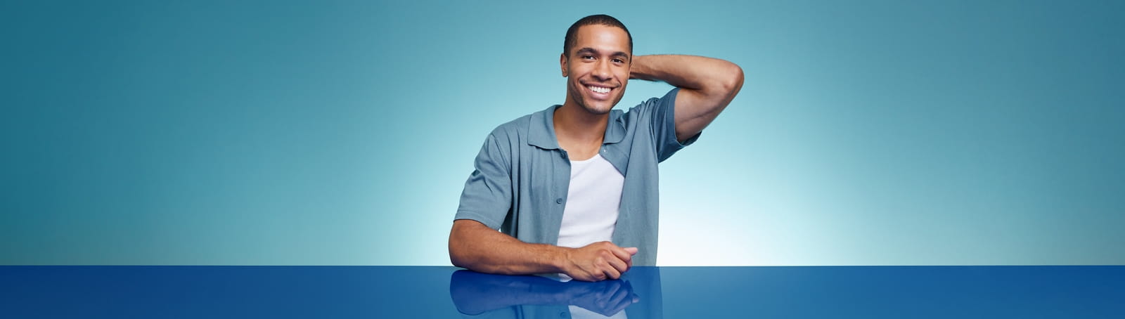 Man smiling in blue and white shirt