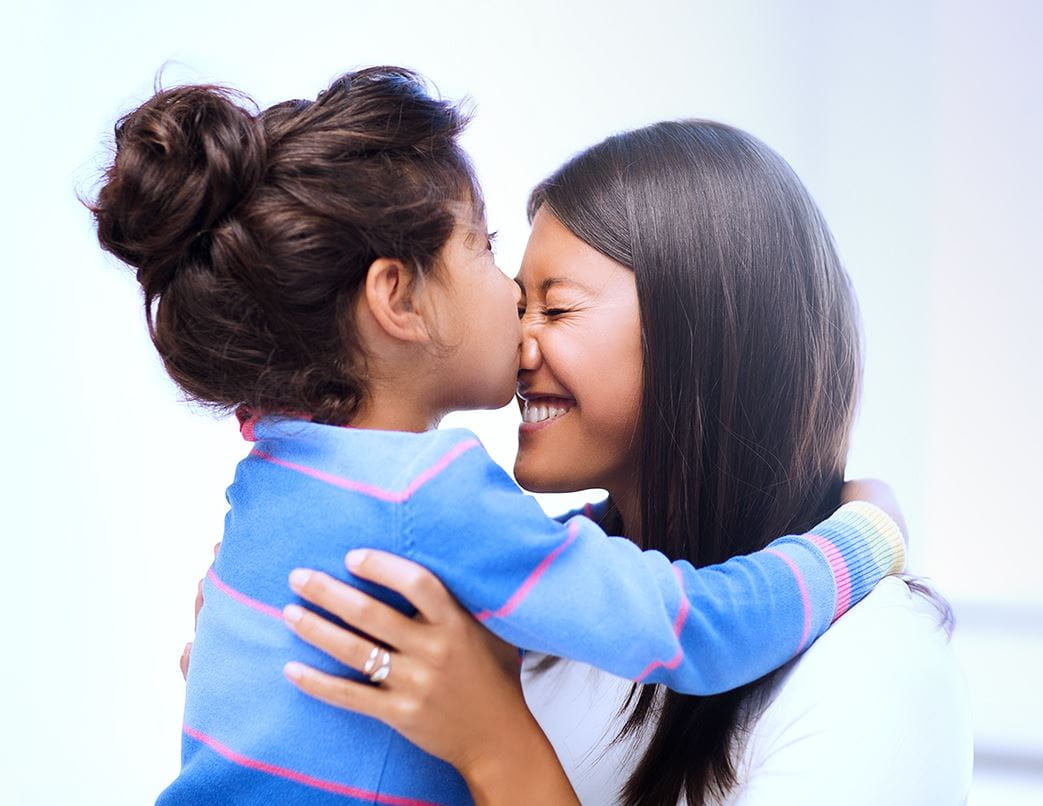 little girl kissing her mom