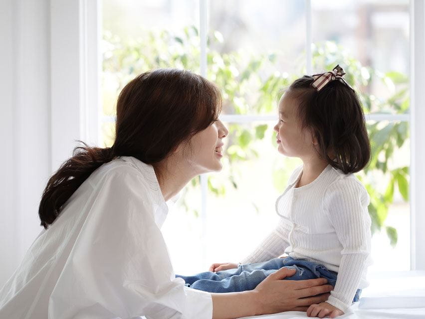 mom and daughther wearing white shirt