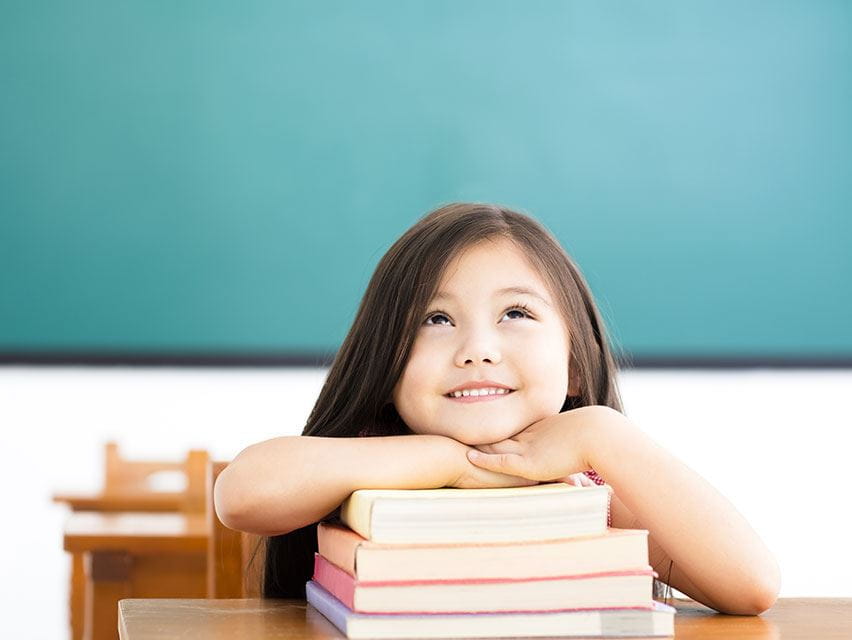 little girl and her stack of book