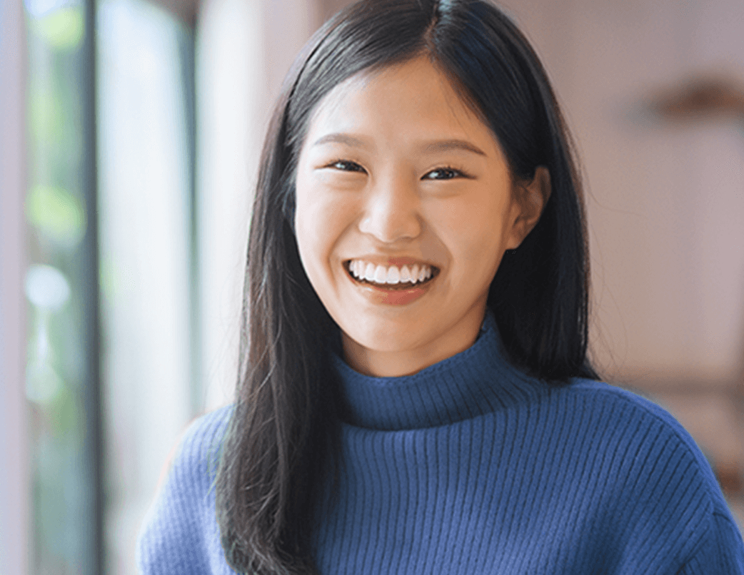 woman in blue turtle neck smiling