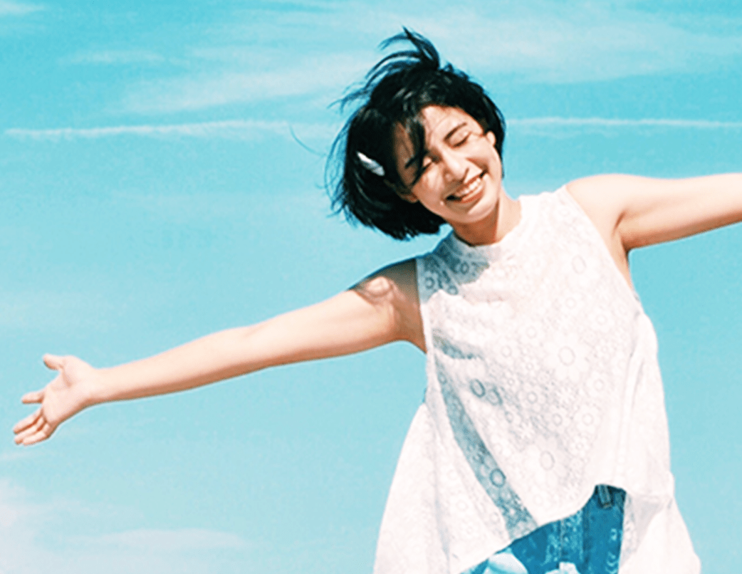 woman with white blouse spreading her arms