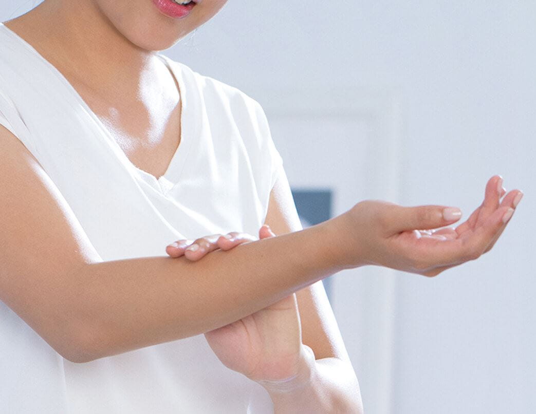 a person in white shirt touching their arm