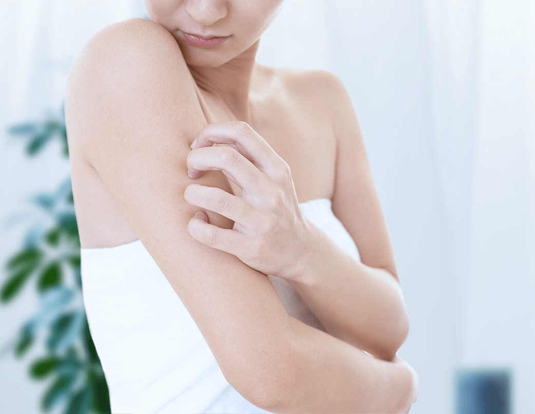 woman scratching her arm