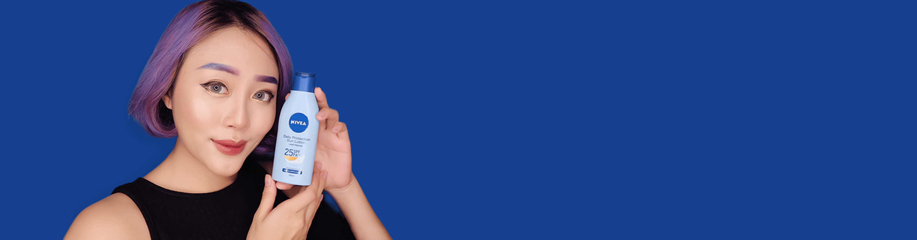 woman with purple hair holding NIVEA SUN