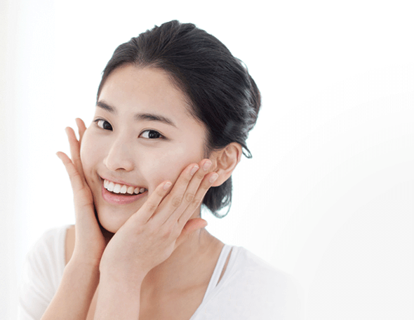 woman touching her cheek with both hands