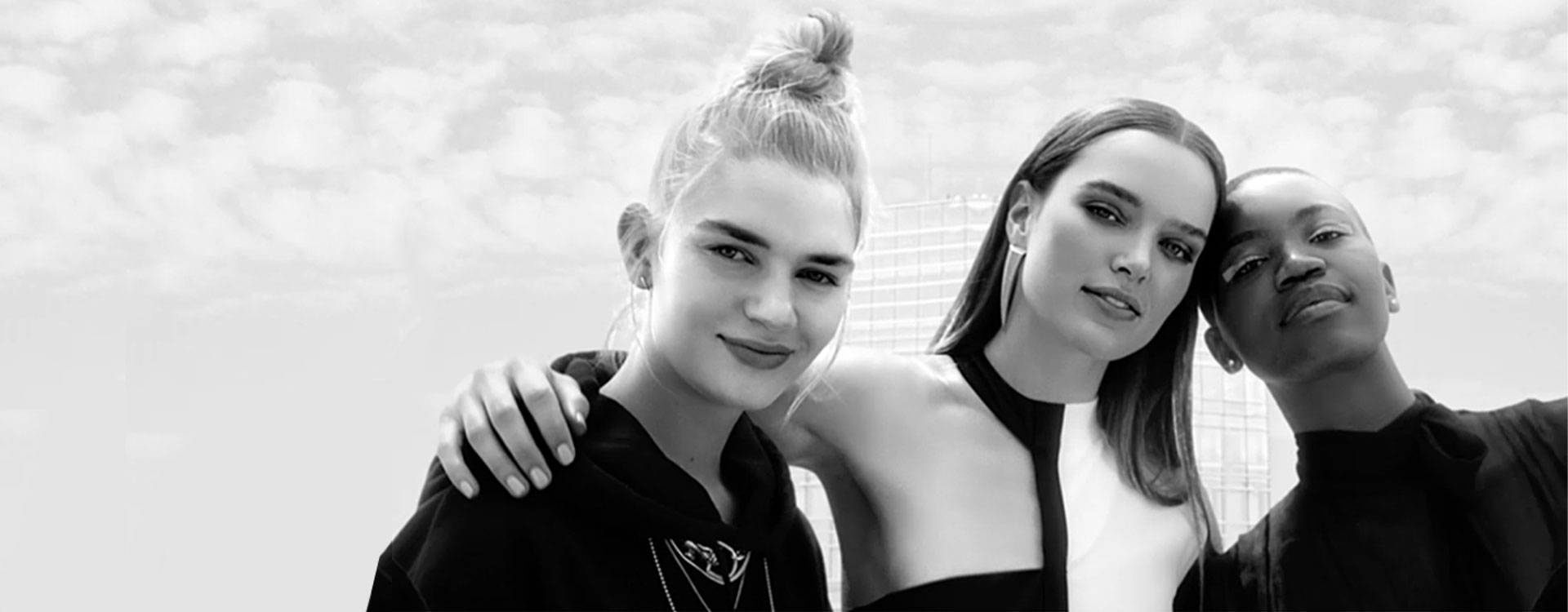 three women posing in black and white