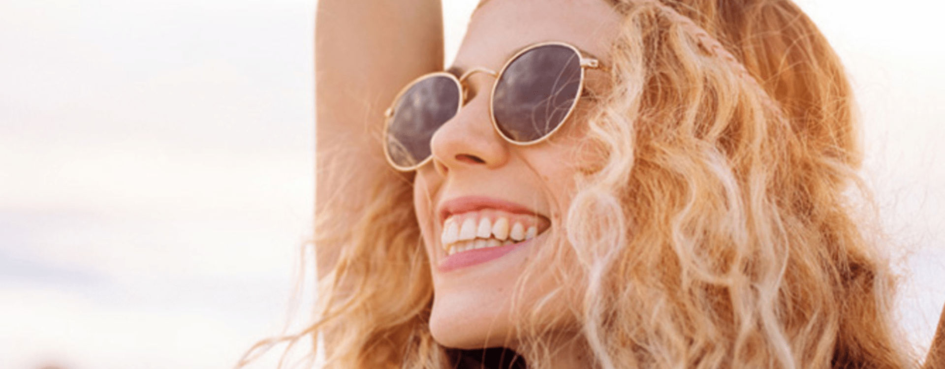 woman smiling wearing sun glasses