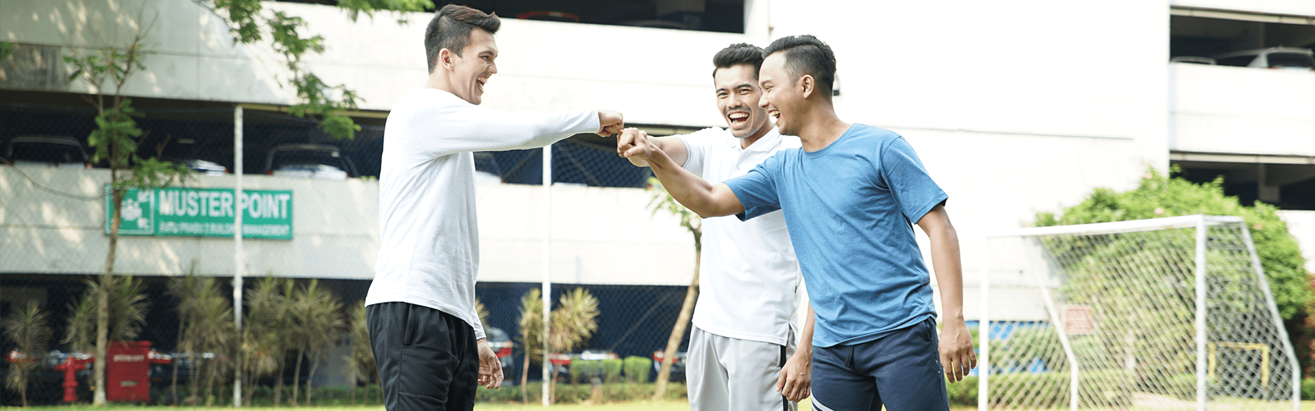 Three men doing fist bump