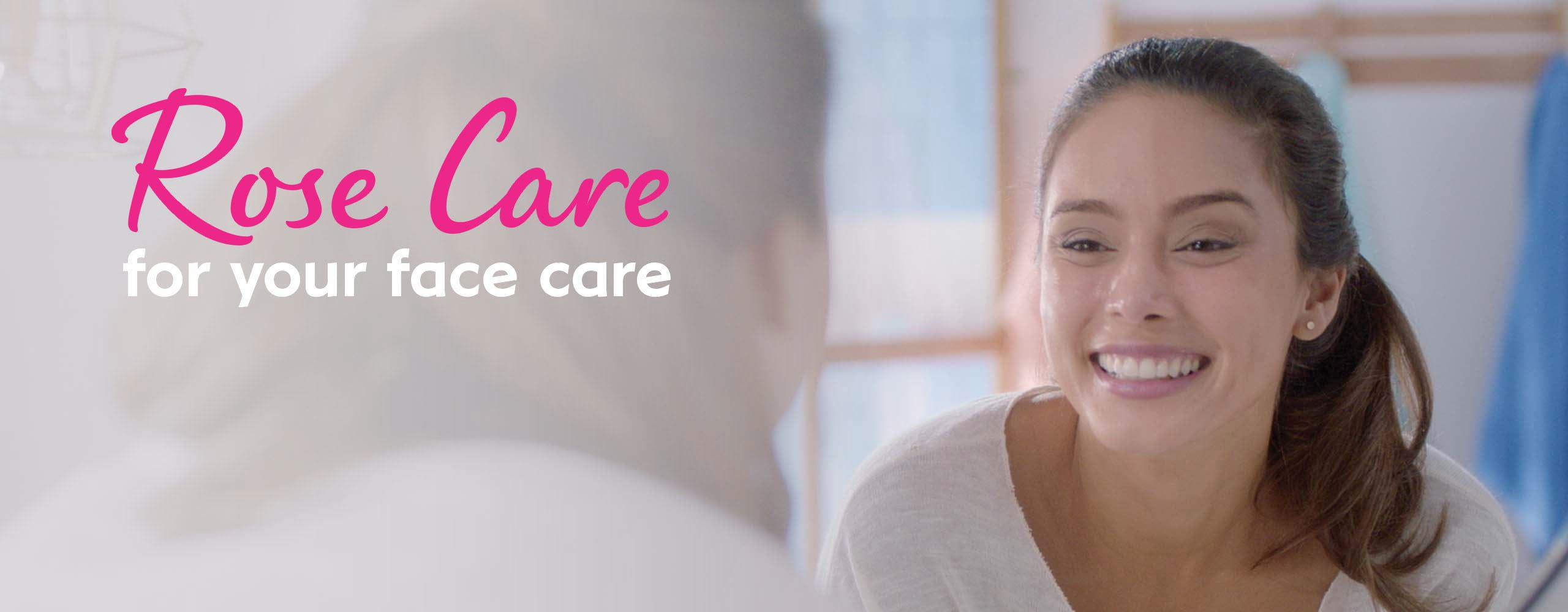 A Woman Looking at her Face in the Mirror Happily after Using Nivea Rose Care Face Care Products