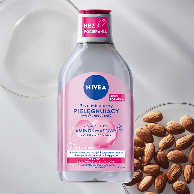 A bottle of NIVEA Micellar Water for Dry Skin lays on a red bubble textured background.