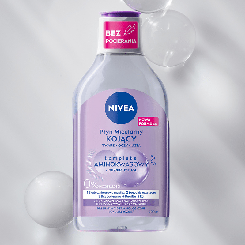 A bottle of NIVEA Micellar Water for Sensitive Skin lays on a purple bubble textured background.