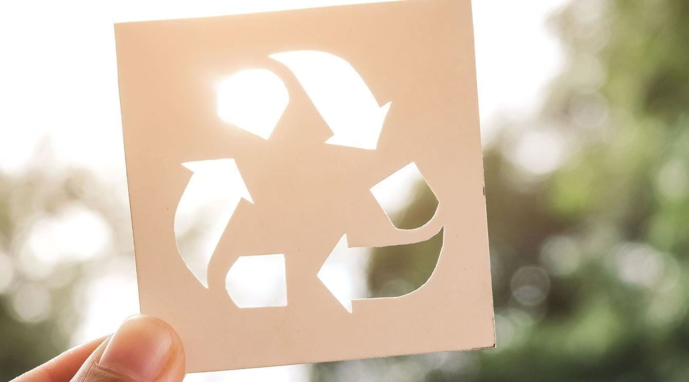 Cartão com recorte de símbolo da reciclagem