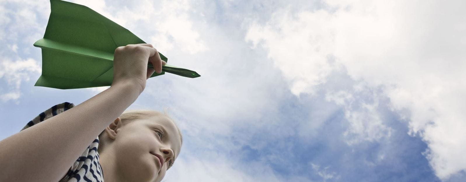 criança com avião de papel