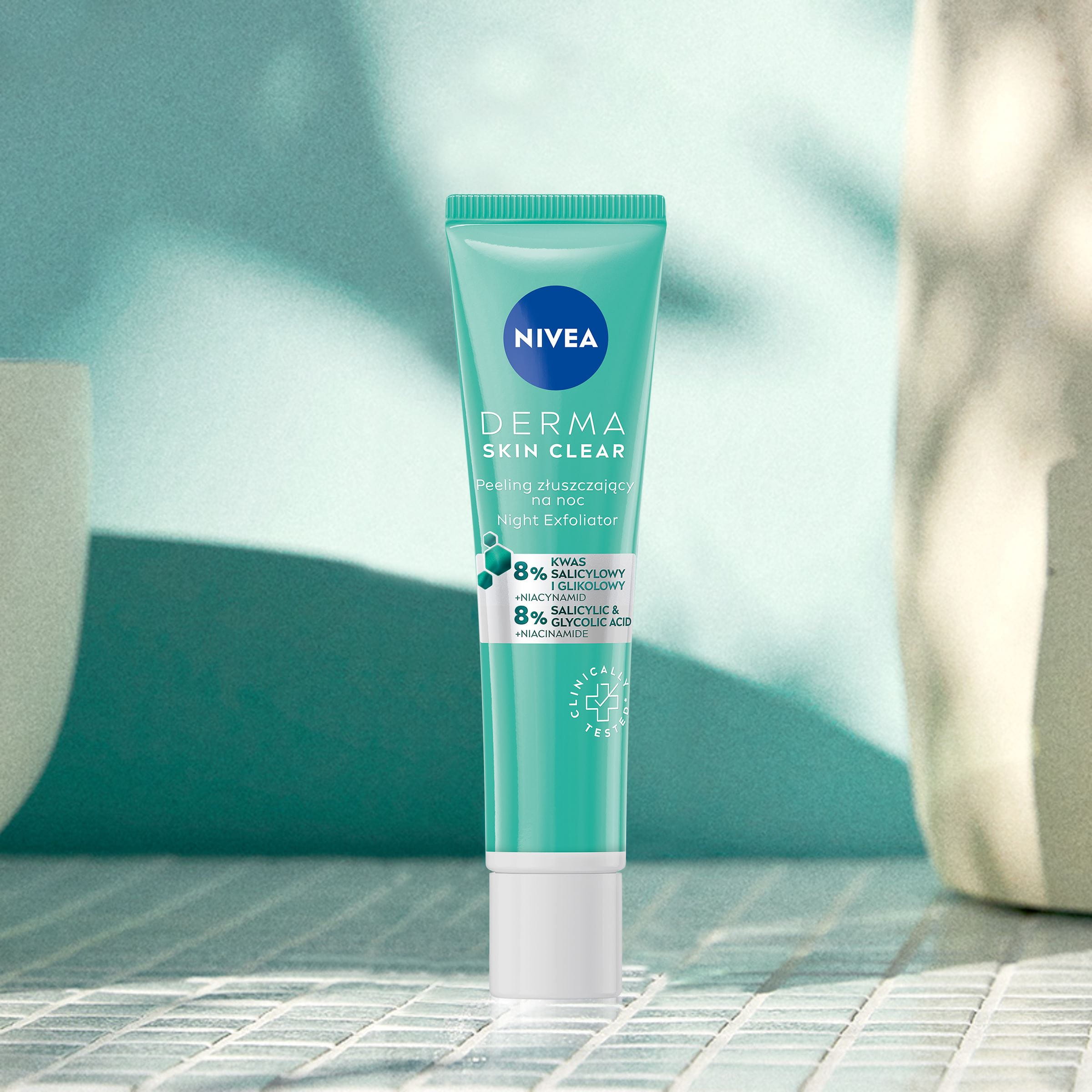 Nivea Skin Clear Night Exfoliator laying on a tile bathroom counter.